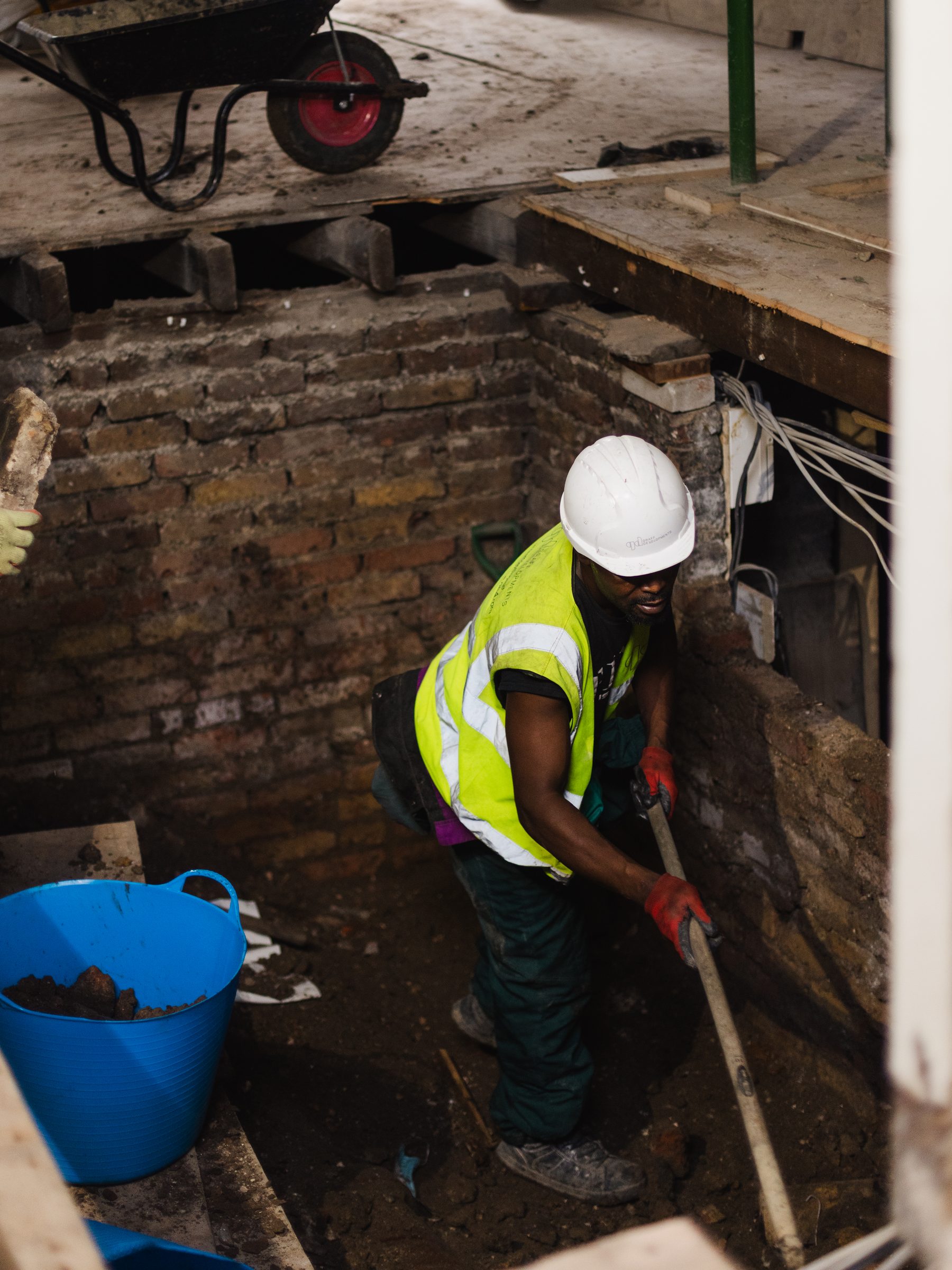 Worker digging out the basement level