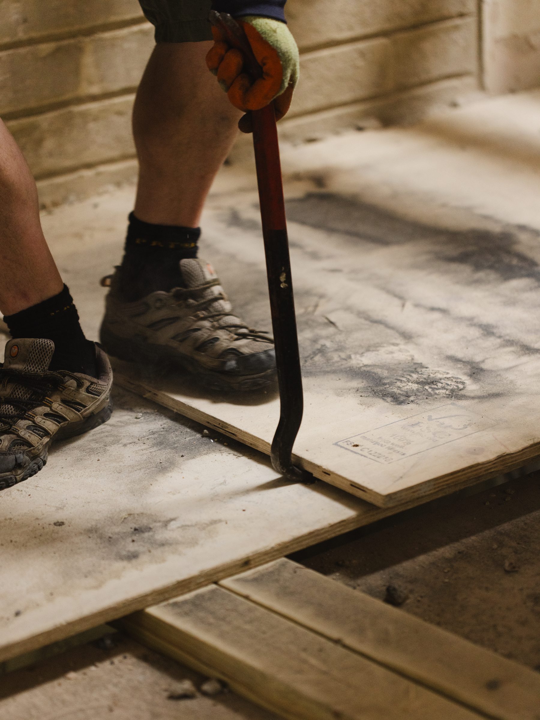 Lifting floorboards with a crowbar